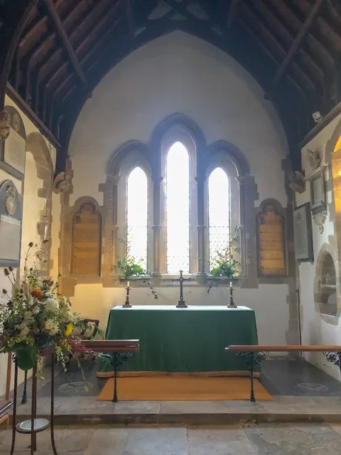 The altar at All Saints, Durrington, beneath three lancet windows