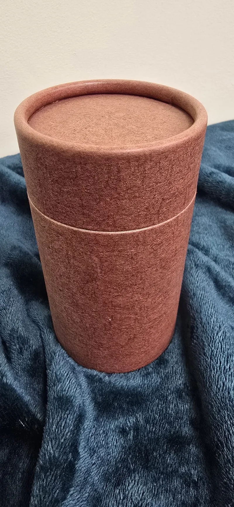 A biodegradable urn in mottled burgundy