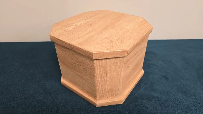 A hexagonal casket in light oak